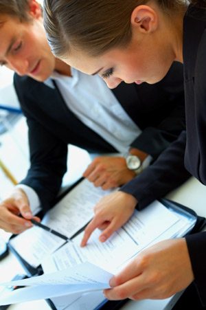 Two business people working on a document.