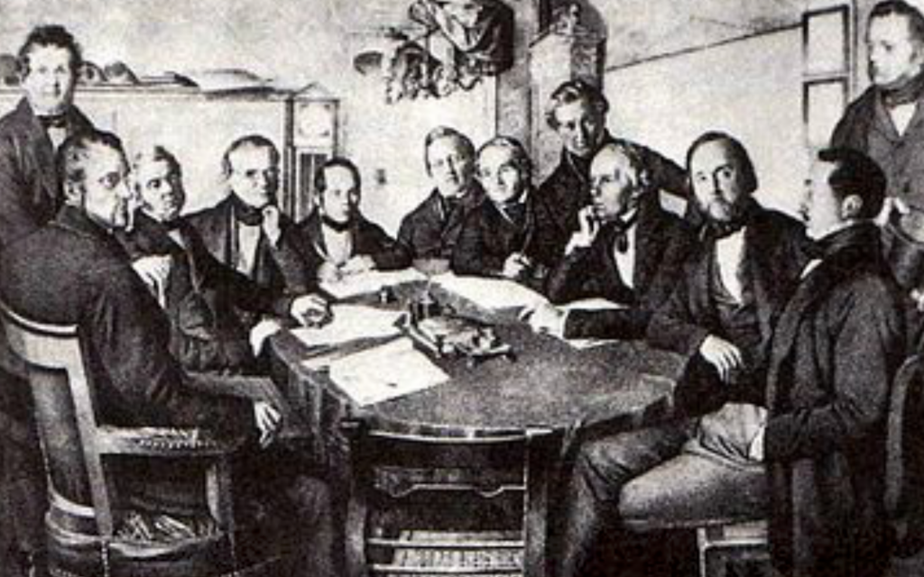 A group of men sitting around a table.