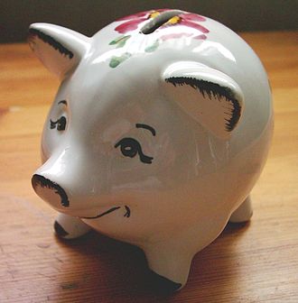 A piggy bank sitting on a wooden table.
