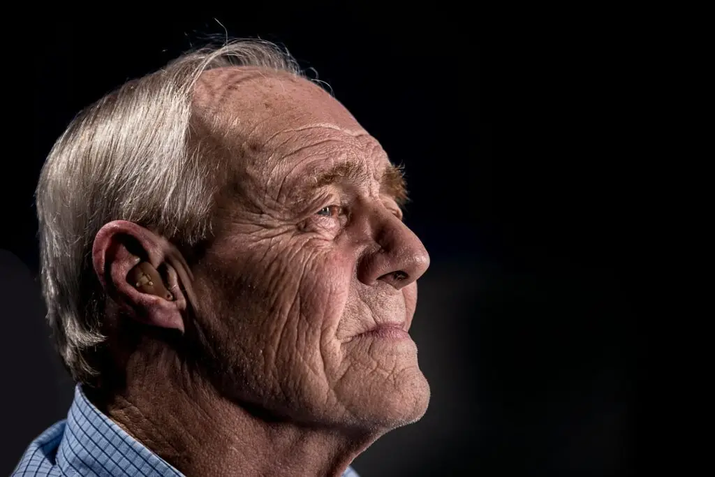 An older man looking up at the sky.